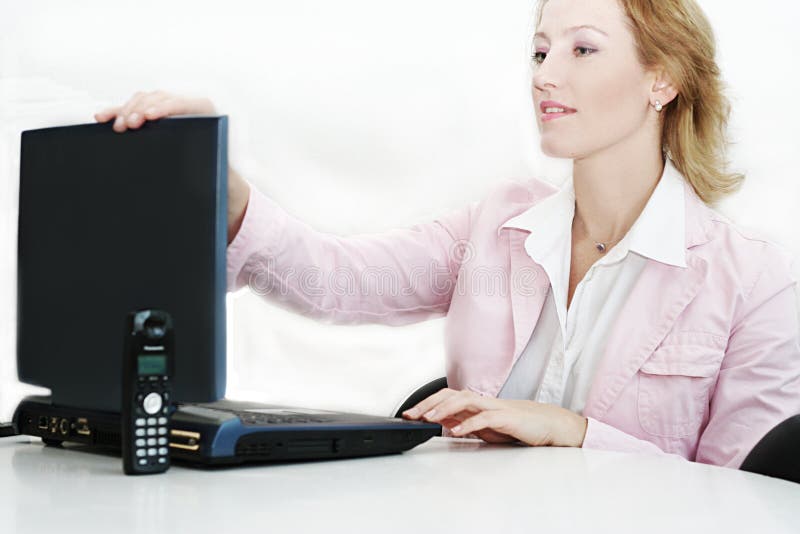 Woman at work place with laptop