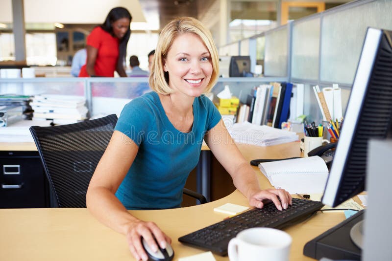 Woman Working At Computer In Modern Office