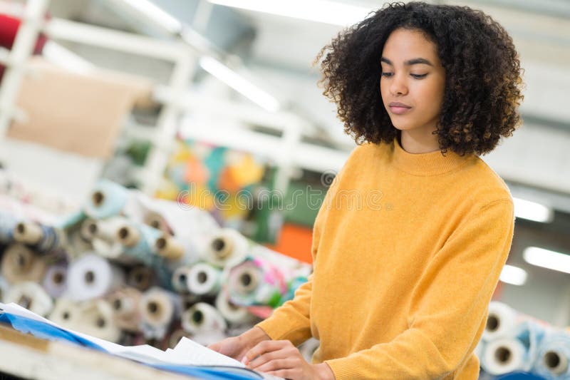 Woman working in industrial busy sewing workplace royalty free stock photo