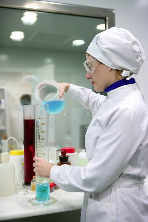 Woman working laboratory, glass cylinder vase