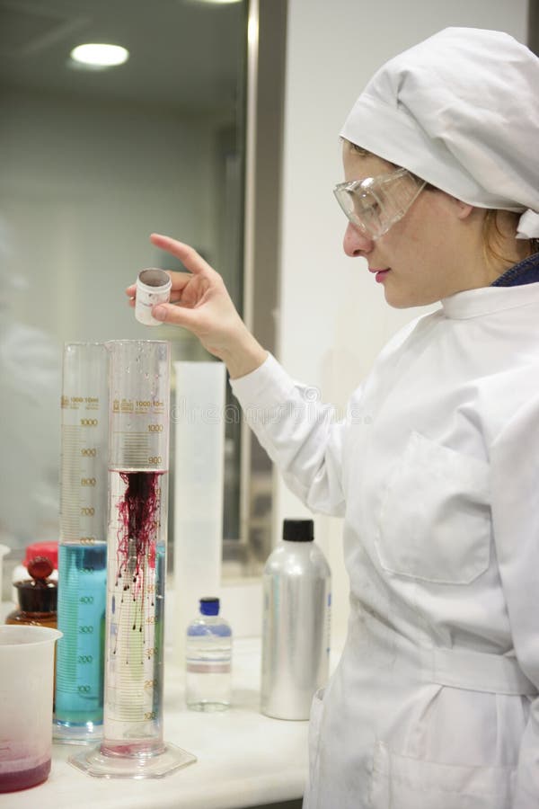 Woman working laboratory, glass cylinder vase