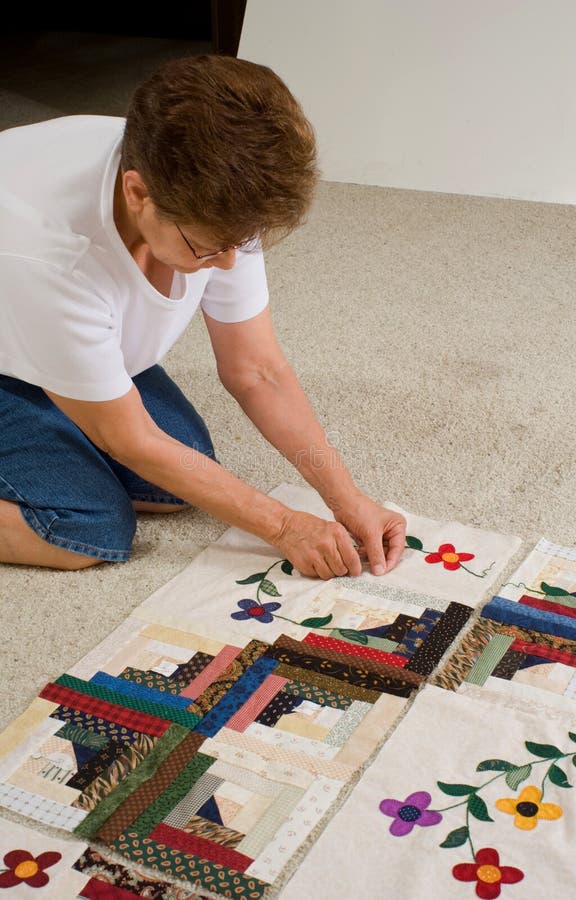 Woman working on quilt.