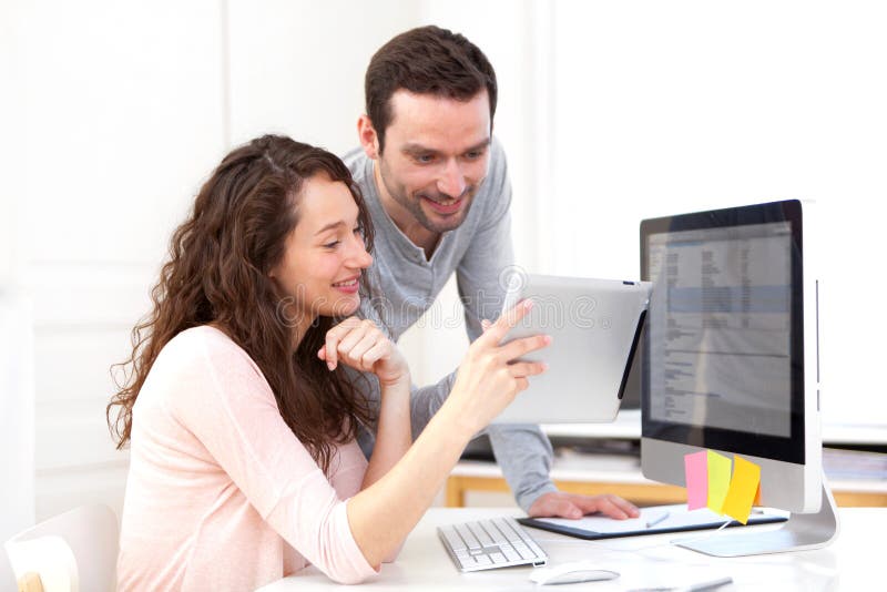 Woman working on tablet with her co-worker stock images Woman working on tablet with her co-worker stock images
