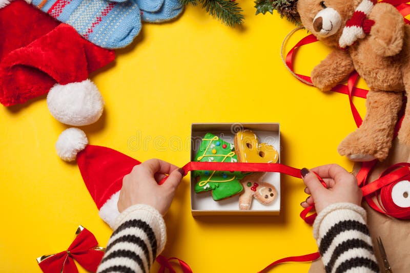 Woman wrapping gingerbread cookie