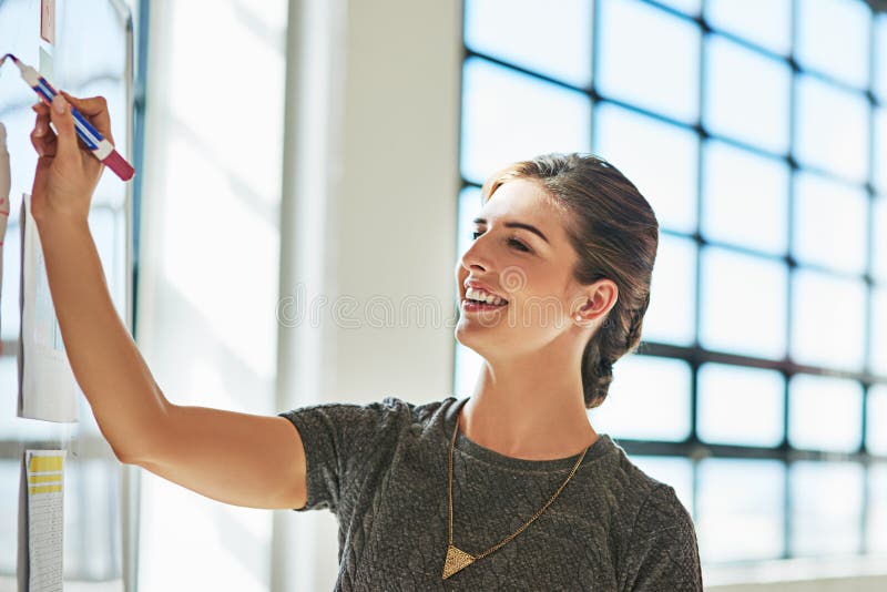 Woman, writing and board for presentation, vision or brainstorming for idea, goals and strategy. Creative leader royalty free stock image