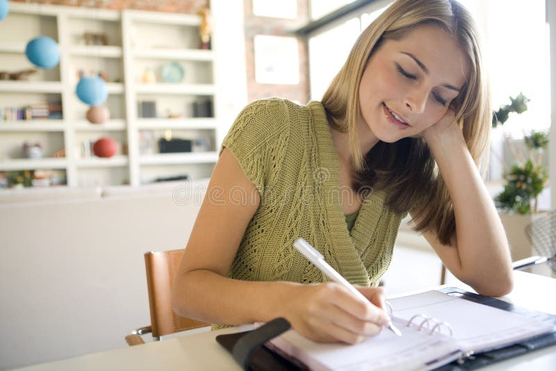 A woman writing in her agenda