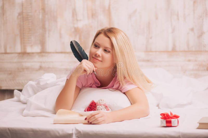 woman-writing-love-letter-feather-pen-attractive-inspired-vintage-to-valentines-day-lying-bed-holding-49189404.jpg