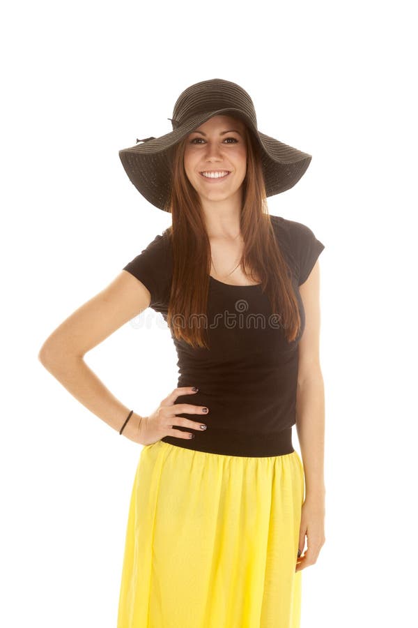 Woman yellow skirt black hat smile