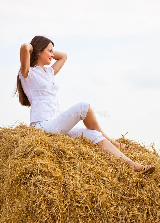 Womanis sitting on a straw