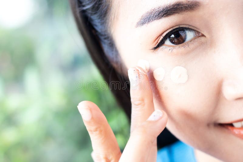 Women are applying concealer under the eyes stock photos