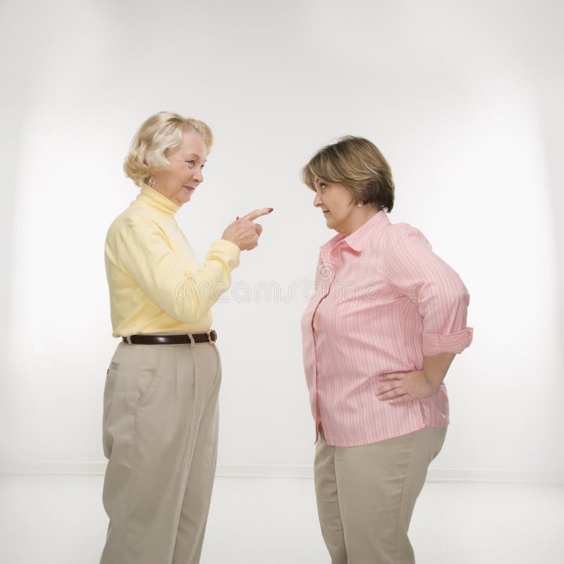 Caucasian senior woman and middle aged woman face to face arguing. Caucasian senior woman and middle aged woman face to face arguing.