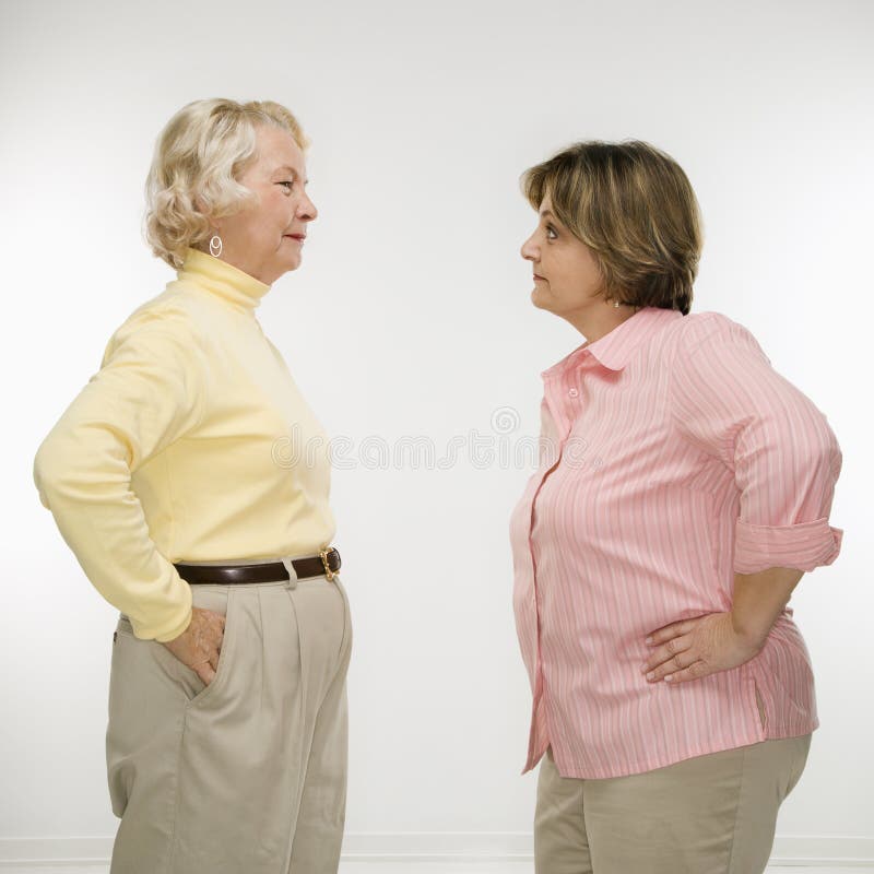 Caucasian senior woman and middle aged woman face to face arguing. Caucasian senior woman and middle aged woman face to face arguing.