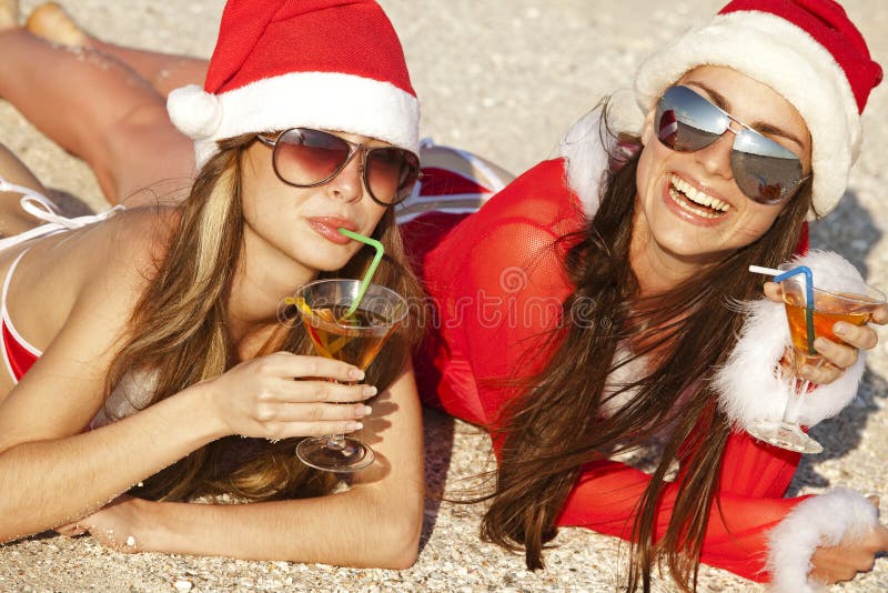 Women in christmas suit with martini on the beach