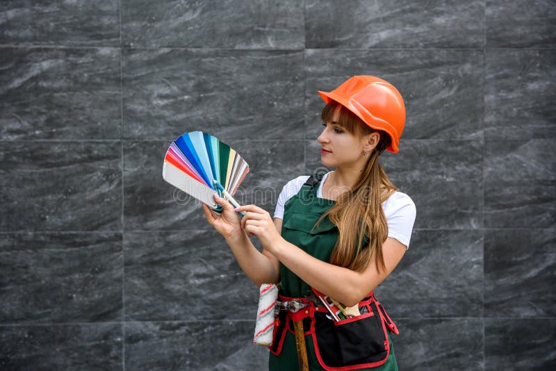 Women in Construction Clothes and Helmet with Color Sampler Ready for
