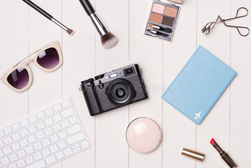 Women Cosmetics and Fashion Items on Table with Camera and Passport ...