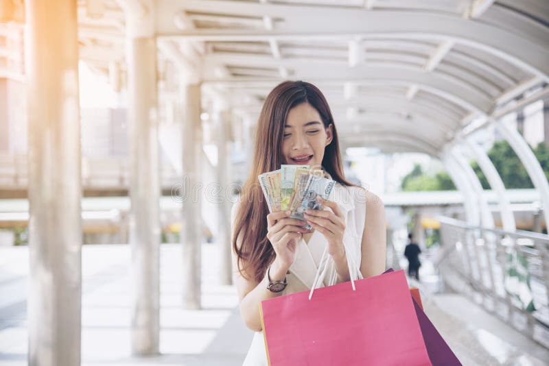 Women crazy shopaholic holding shopping bags , money ,credit card person at shopping malls.Fashionable Woman love online website stock photos Women crazy shopaholic holding shopping bags , money ,credit card person at shopping malls.Fashionable Woman love online website stock photos