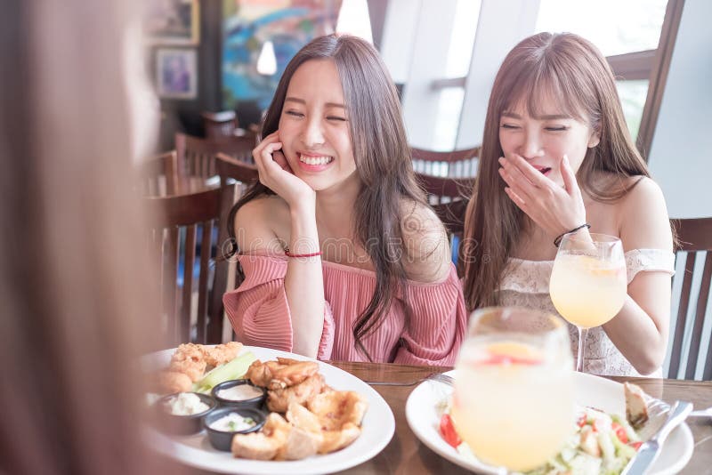 Beauty women smile and dine in restaurant. Beauty women smile and dine in restaurant