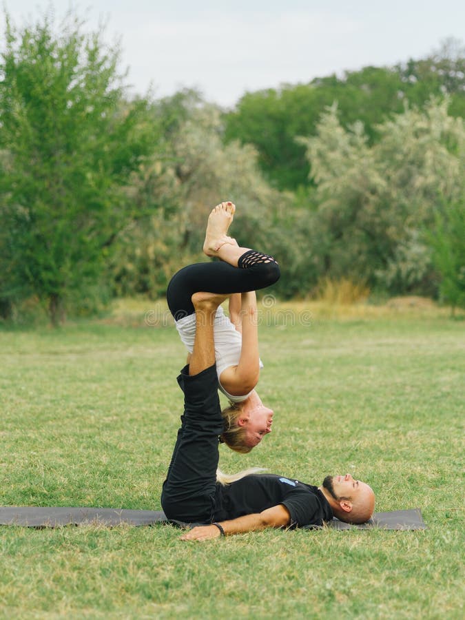 Healthy Lifestyle Modern Activity. Young Couple Doing Acro Bird Yoga ...