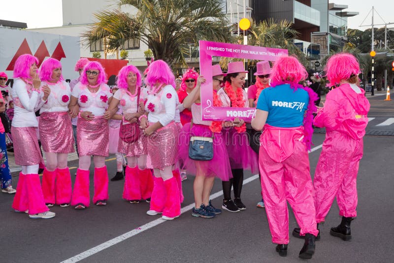Women Dressed in Comedic Pink Costumes at Breast Cancer Awareness