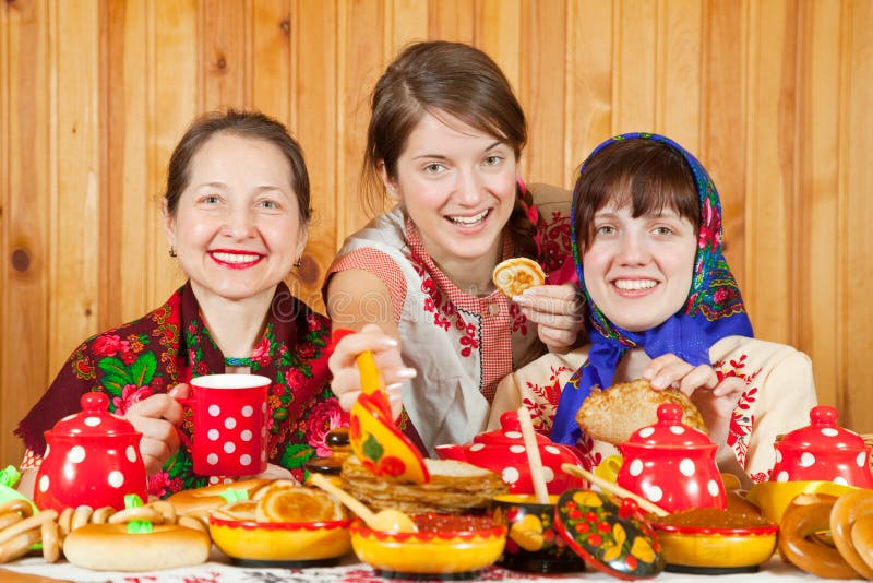 Women eats pancake with caviare