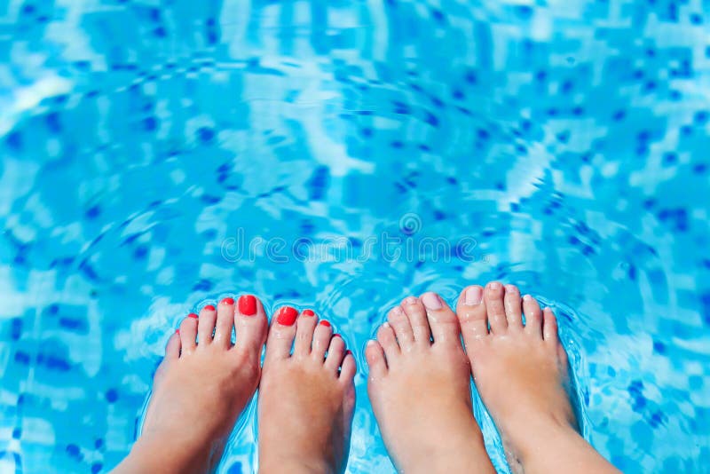 Women foot splashing in swimming pool royalty free stock photo