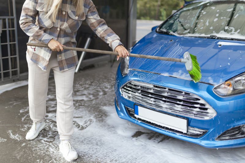 The Women Herself at the Car Wash Washes the Car with a Brush Stock Photo Image of outdoors