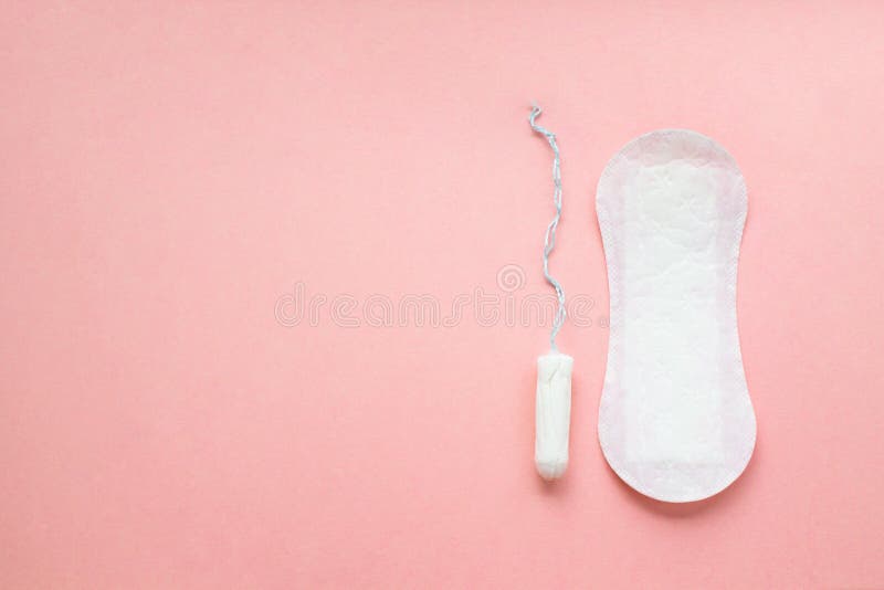 Women intimate hygiene products - sanitary pad and tampon on pink background. royalty free stock photos Women intimate hygiene products - sanitary pad and tampon on pink background. royalty free stock photos