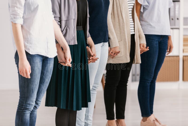 Women with issues supporting together during group therapy