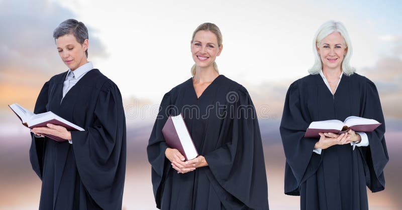 Women Judges holding books in front of sky clouds stock photo Women Judges holding books in front of sky clouds stock photo