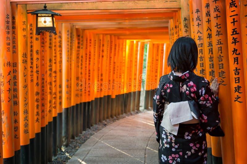 Women in kimono stand at Red Torii gates in Fushimi Inari shrine, Kyoto, Japan royalty free stock photo Women in kimono stand at Red Torii gates in Fushimi Inari shrine, Kyoto, Japan royalty free stock photo