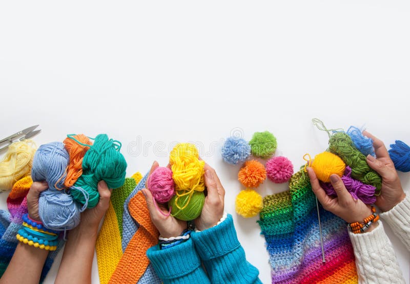 The women knit and crochet colored fabric. View from above. stock photos The women knit and crochet colored fabric. View from above. stock photos