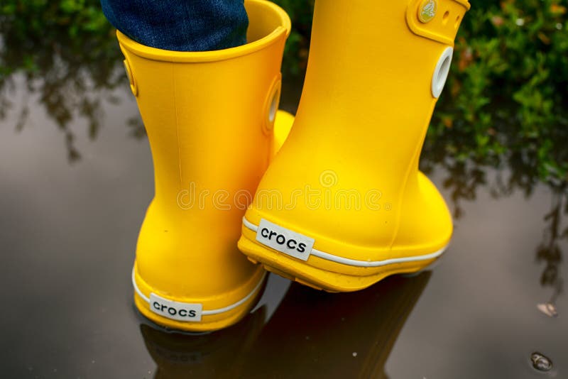 Women Legs in Yellow Crocs Boots in the Puddle Editorial Stock Image -  Image of crocs, boots: 155739779