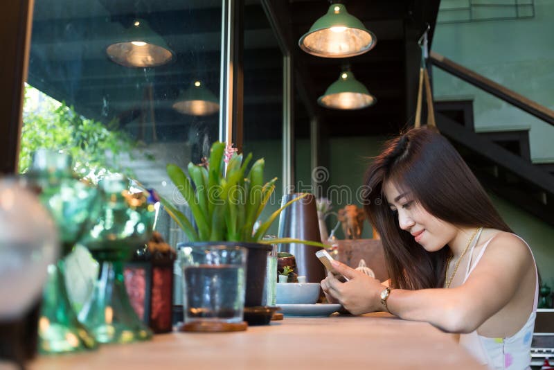 Women lifestyle using a mobile phone in cafe coffee