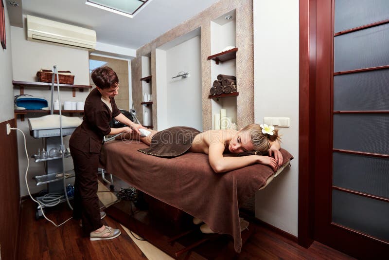 A woman lying down doing cryolipolysis treatment. stock image A woman lying down doing cryolipolysis treatment. stock image