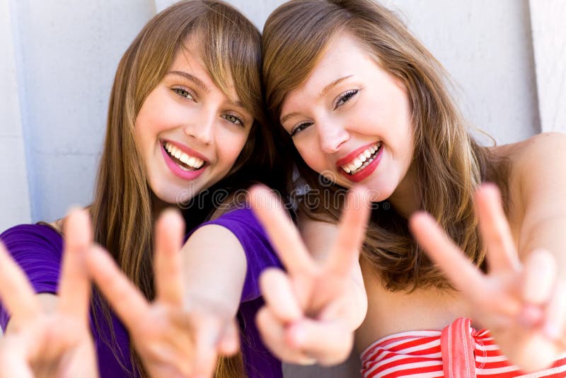 Teenage girls making a peace sign. Teenage girls making a peace sign