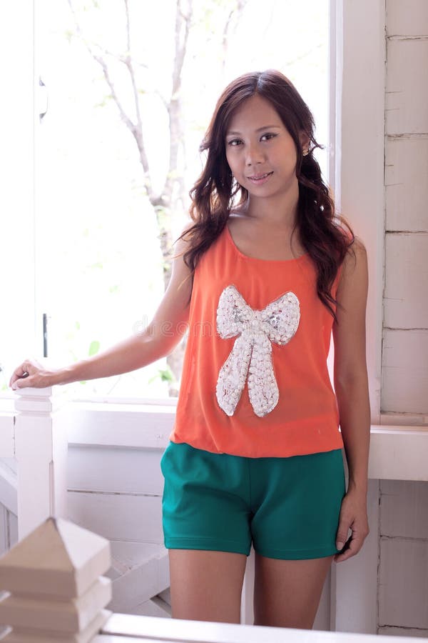 Women in orange shirts and green shorts