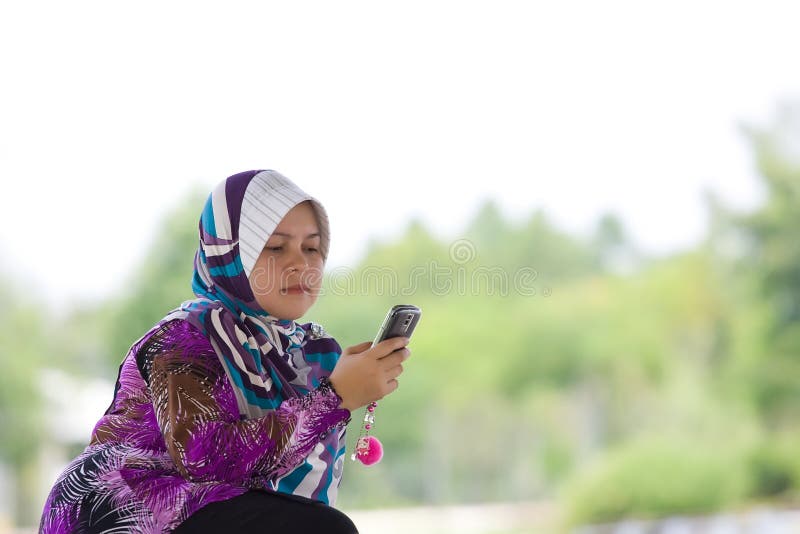 Women playing her mobile phone