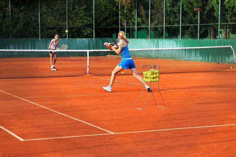 Women playing tennis outdoors