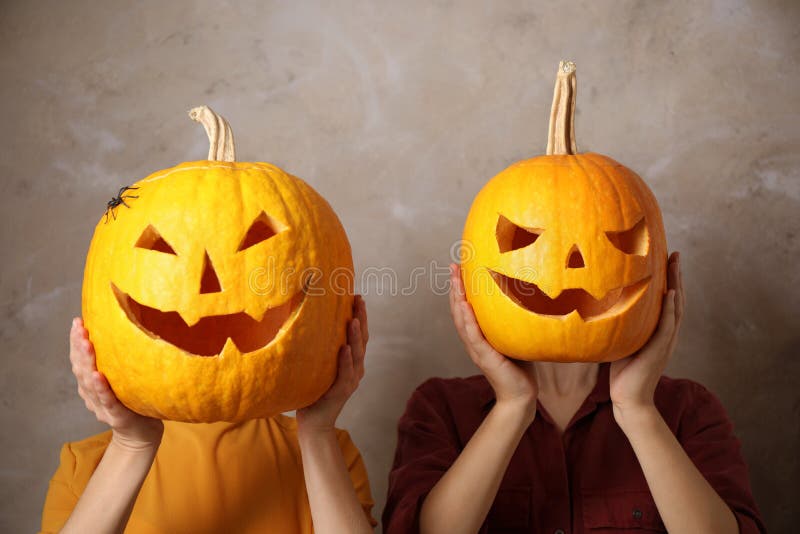 Women with Pumpkin Heads Against Background. Jack Lantern - Traditional ...