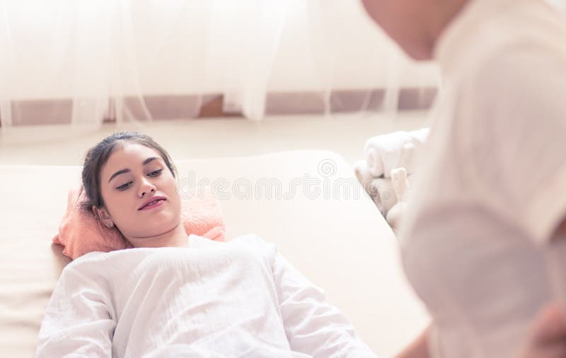 Women Is Relaxing While Thai Therapist Giving Massage Stock Image