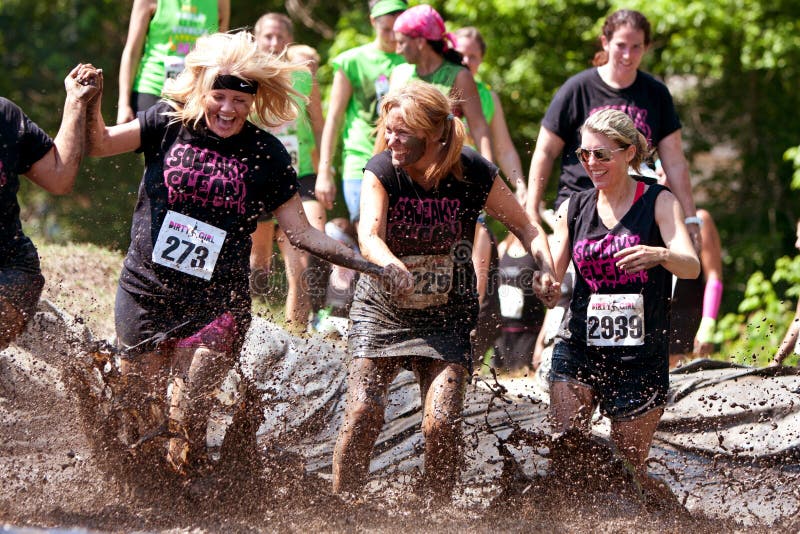 Women Run And Splash Through Mud Pit