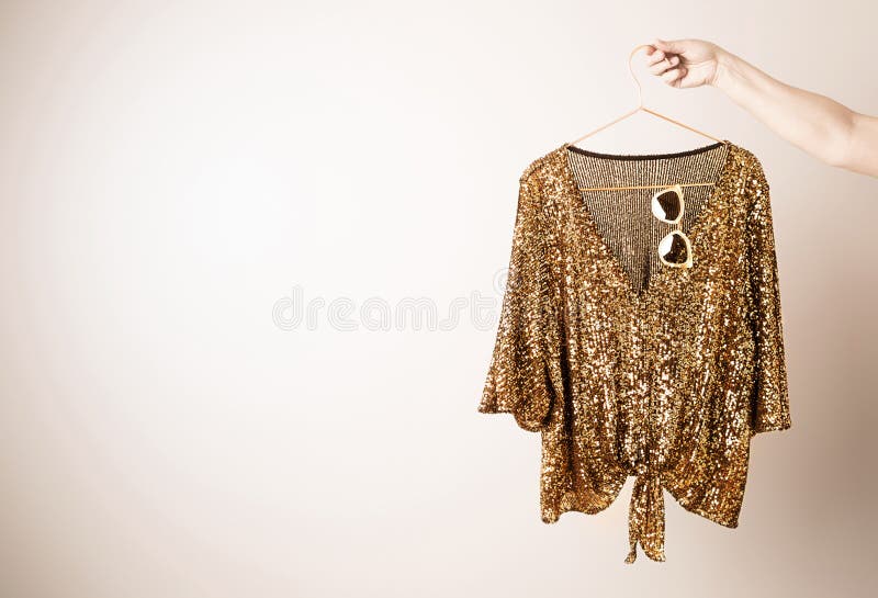 Women`s clothing - gold glittery sequin party top blouse royalty free stock image Women`s clothing - gold glittery sequin party top blouse royalty free stock image