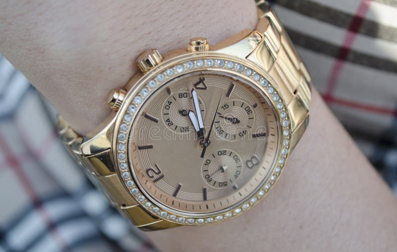 Women s gold watch on the hand