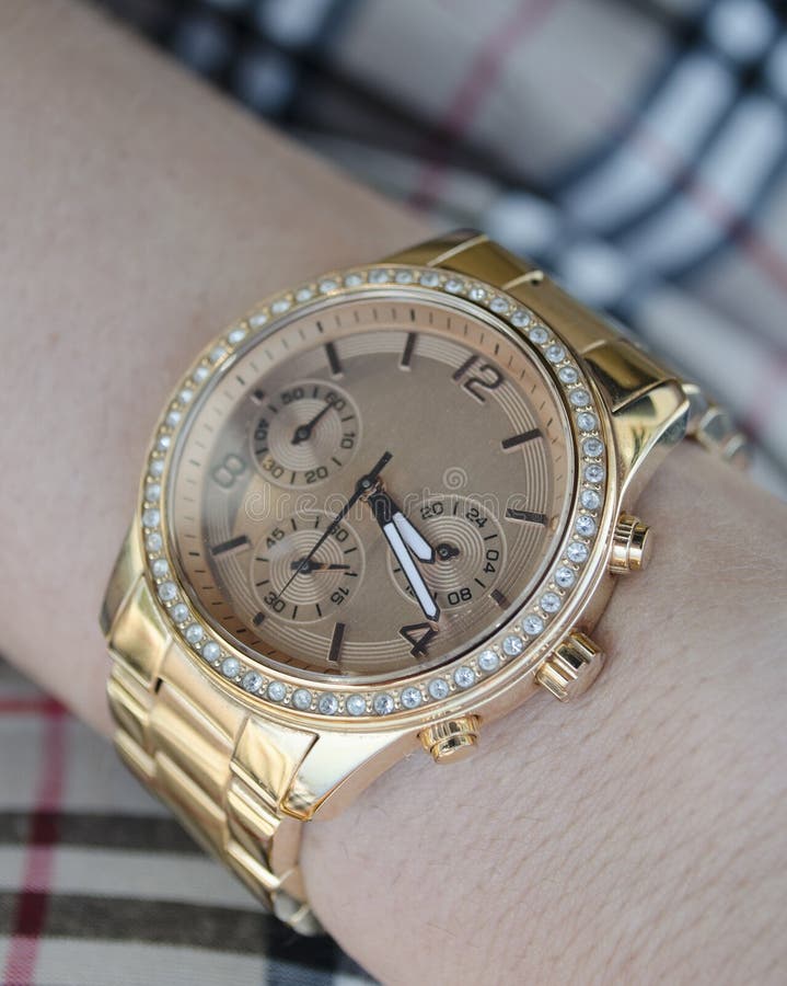 Women s gold watch on the hand