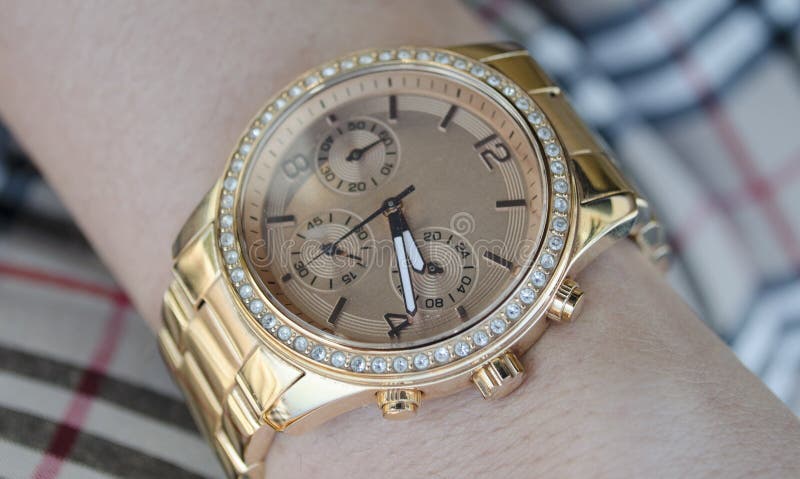 Women s gold watch on the hand