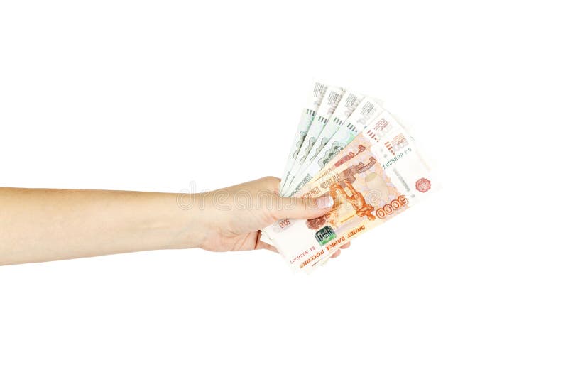 Women`s hand holds russian money on a white background.
