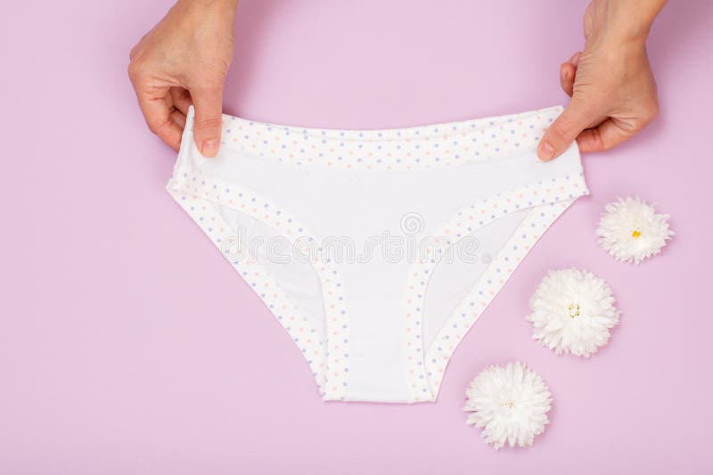 Womenand X27 S Hands With Beautiful Panties And Sanitary Pads On Pink Background Stock Image