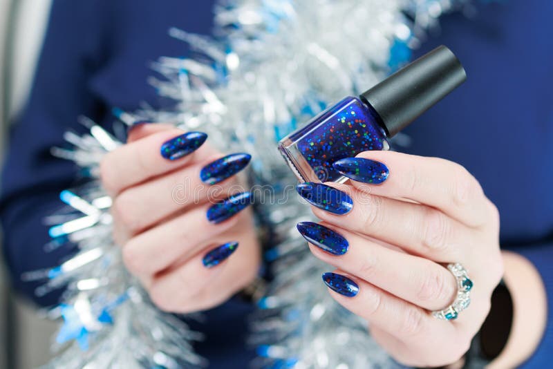 Women S Hands with Long Nails and Bright Blue Manicure Hold a Silver ...