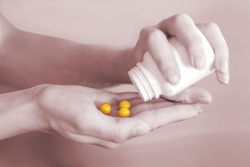 Women`s hands pour out yellow pills from a bottle. Hands of a young girl holding a white jar with round vitamins. The concept of health. Photos of tablets in the trending color of 2021..