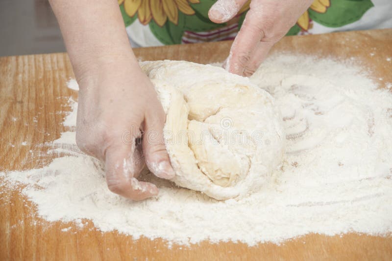 Women's hands prepairing fresh yeast dough. Raw fresh yeast dough stock images, royalty-free photos and pictures